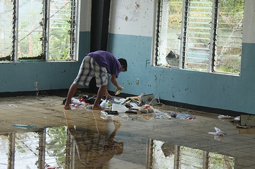 Xavier High School student cleans up a classroom in Chuuk, Micronesia